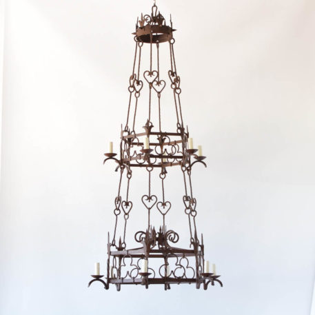 Large French Iron Chandelier with lights on two levels connected by hand forged iron rods with clover and heart motifs in the iron