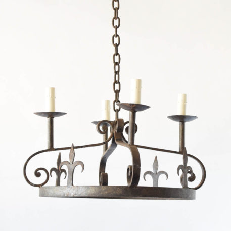Antique iron chandeliers with fleur de lis motif from a French B&B