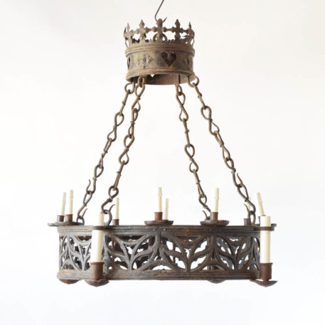 Antique French iron chandelier in the Neogothic style with pierced band and large crown at top