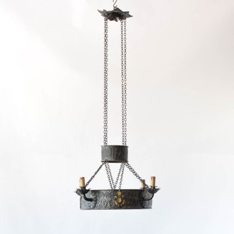 Iron ring chandelier with 4 arms. Suspended by chains with small top ring. Eagle motif details.