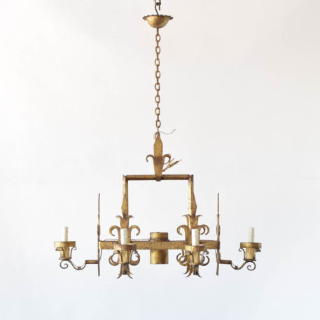 Gilded and elongated Spanish chandelier with 6 arms and one center light. Features Florida lee details.