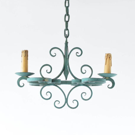 Small French Country Chandelier having an elongated from and nice iron curls