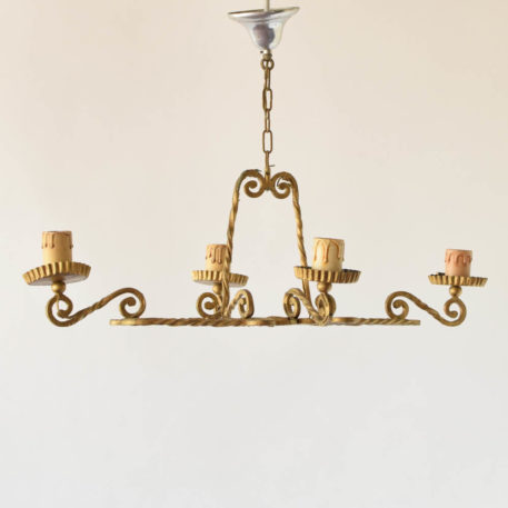 Simple iron chandelier having an elongated form made from twisted square bar stock