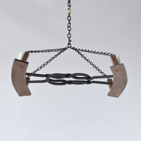Vintage Iron Chandelier with Hand forge knot in center holdig 2 wood fragments