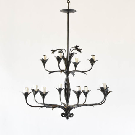 Tall thin leafy chandelier with flower form bobesches and flowers at top