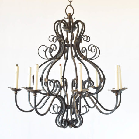 Large French iron chandelier with fleur de lis and rosette decorations on alternating arms