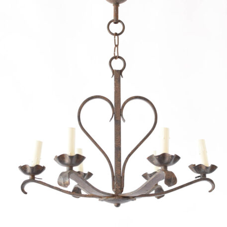 Iron chandelier with a rustic heart design in the center