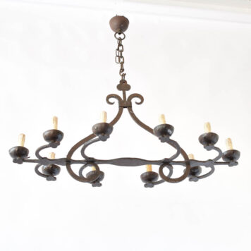 Rustic elongated chandelier with clovers under bobeasches and at top of column
