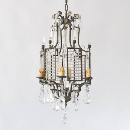 Bronze chandelier with hanging crystal prisms and bronze panels containing a grid of crystal beads