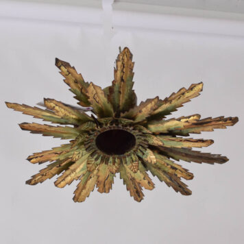3 rows of jagged leaves surround a single down light in this Spanish ceiling fixture