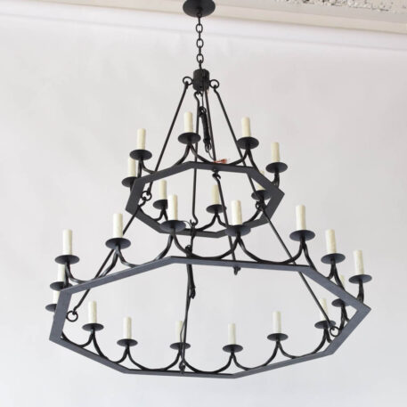Custom made iron chandelier with 2 hexagon levels supporting twisted iron bars holding 24 candles
