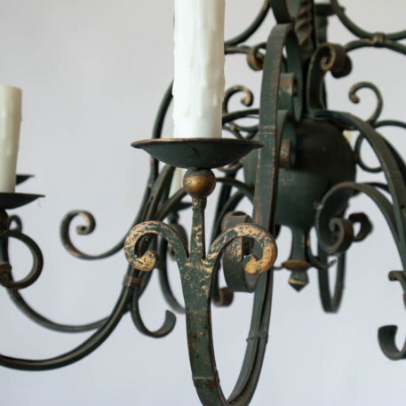 Flemish or French style pair of iron chandeliers with scroll arms and green color decorative column and gold details