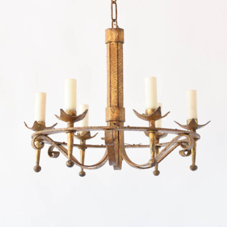 Vintage gilded iron chandelier from Barcelona by the famed Ferro Art forge. Chandelier has a simple central column with six iron strap arms in torch form