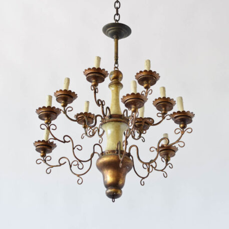 fancy Italian style vintage gilded wood and iron chandelier with scrolls and wooden finial and filigree arms with white beige painted column