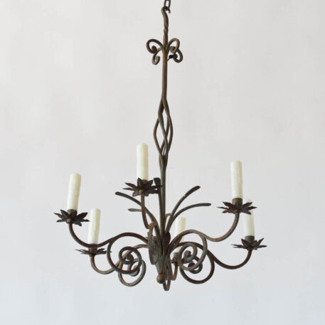 tall vintage wrought iron chandelier with scrolls and leaves and leafy bobesches or star shaped candle cups