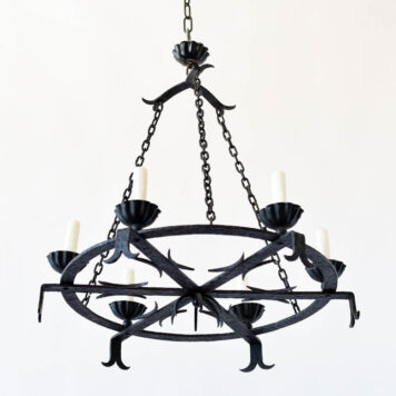A 6 light, large flat Iron chandelier with 6 whiskers at the bottom.