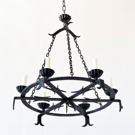 A 6 light, large flat Iron chandelier with 6 whiskers at the bottom.