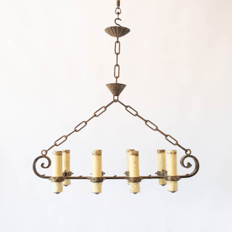 Long Elongated gilded gold Spanish chandelier with large fat candles and scrolls wrought iron vintage rustic finish