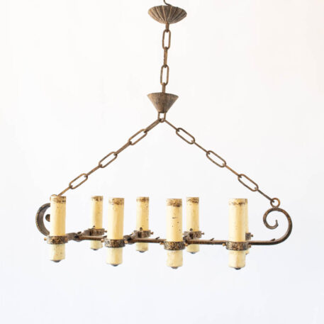 Long Elongated gilded gold Spanish chandelier with large fat candles and scrolls wrought iron vintage rustic finish