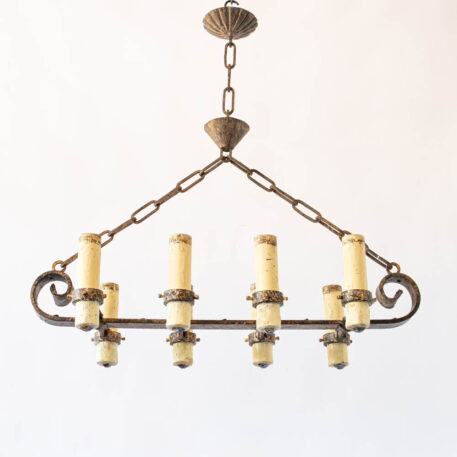 Long Elongated gilded gold Spanish chandelier with large fat candles and scrolls wrought iron vintage rustic finish