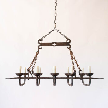 Elongated rusty iron chandelier with hooks heavy twisted wrought iron rustic simple