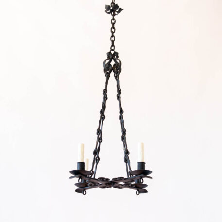 Flat iron 4 light chandelier with scrolls and hook chain and flower tall cross shaped