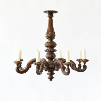 An 8 light carved wood antique chandelier